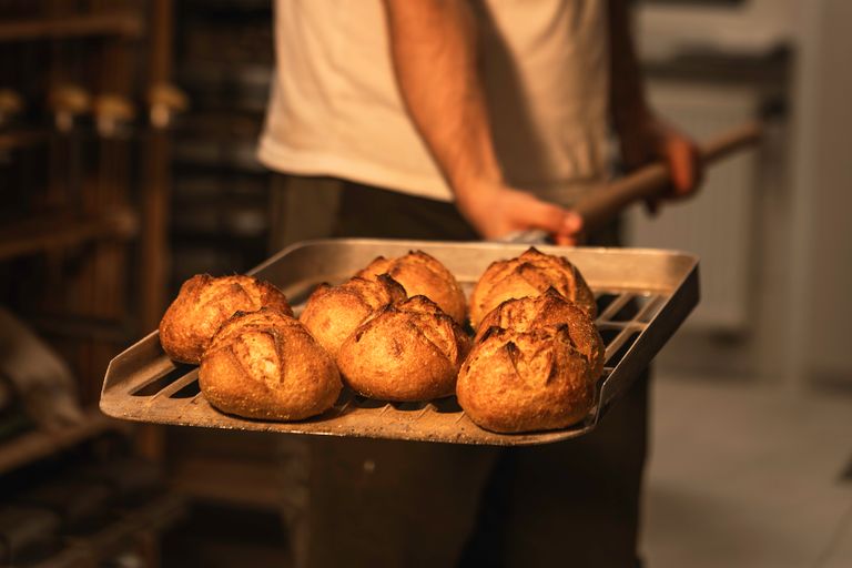 Close-up of freshly baked artisan bread in a bakery, exuding warmth and craftsmanship.